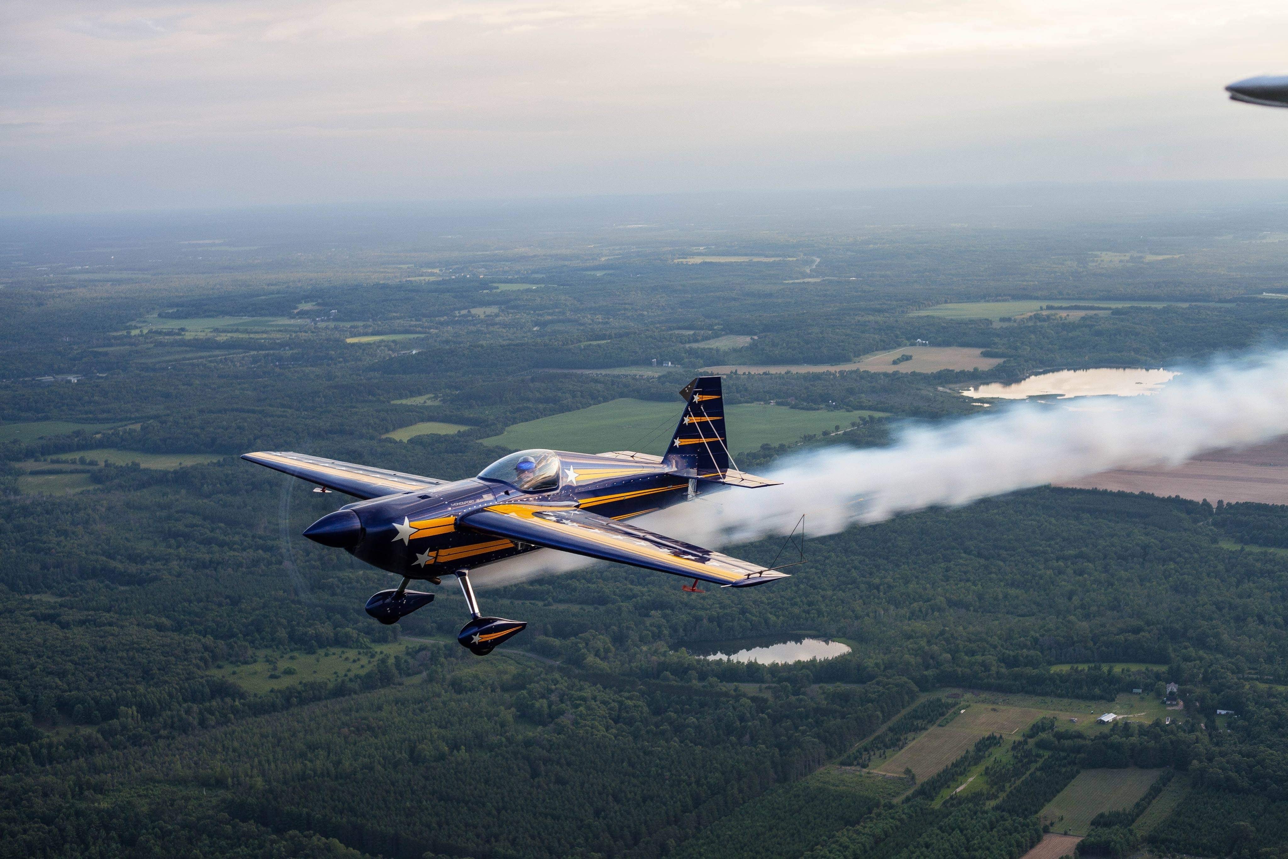 aerobatic-plane-in-flight-leaving-behind-a-white-trail.jpg